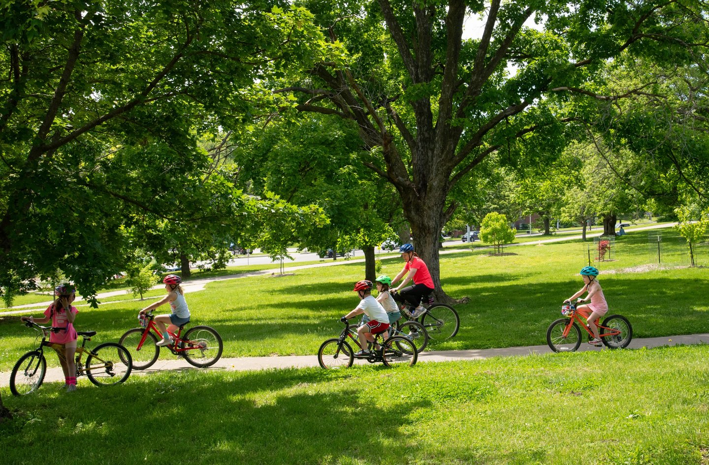 Group of children biking through the park