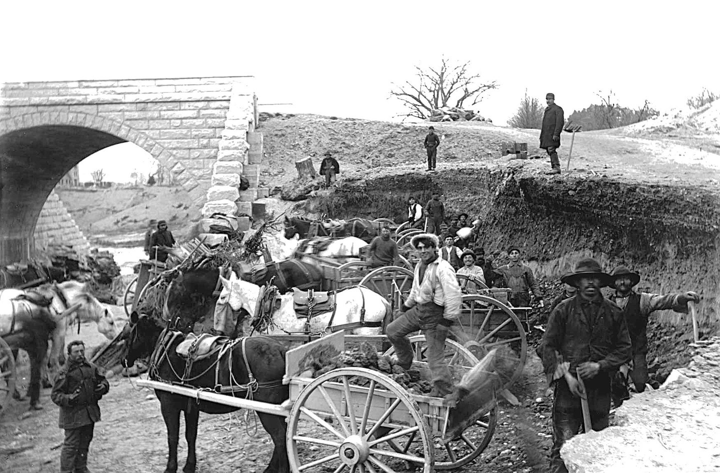 Reservoir laborers loading rocks into a pony cart
