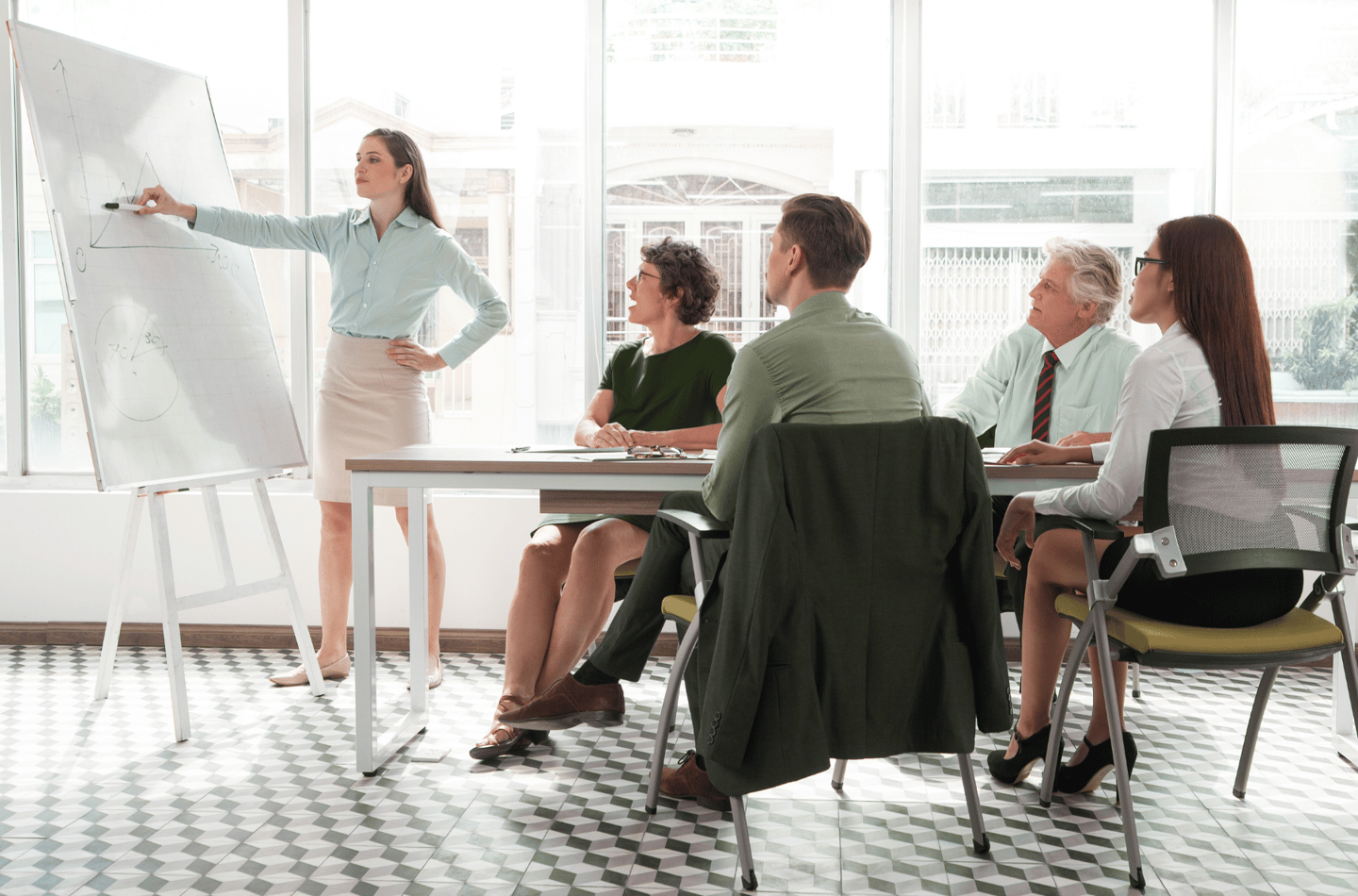a woman in a business suit is standing in front of a white boardroom