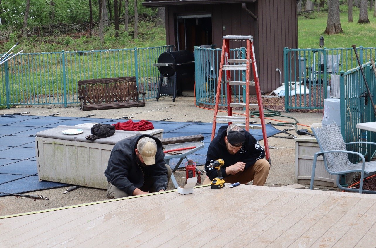 Workers laying composite deck step boards