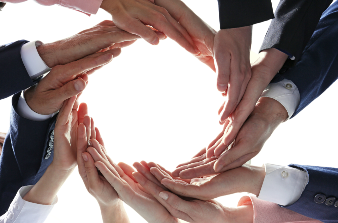 Hands coming together to form a circle