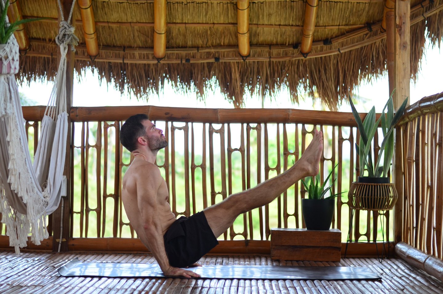 V-Sit on Yoga Mat in Nipa Hut