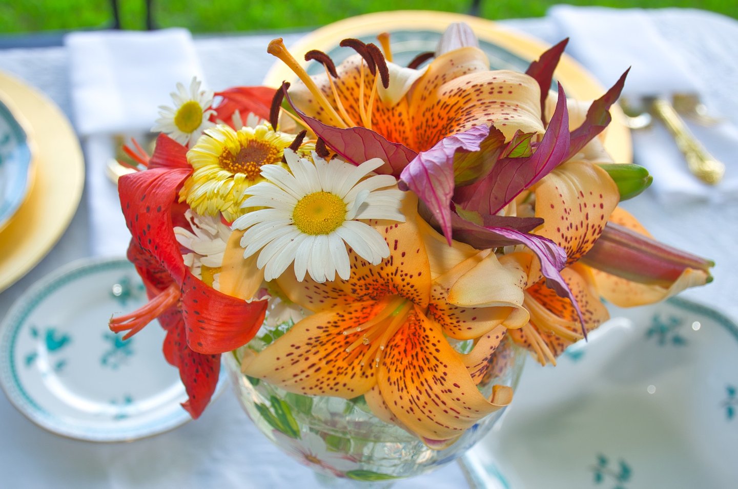 a vase with flowers on a table as wedding decoration