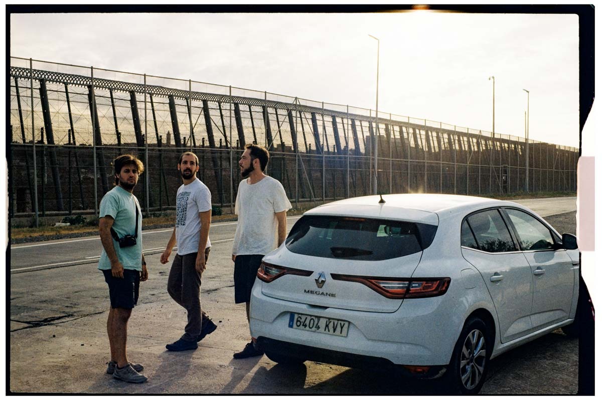 a film crew standing around a car on location
