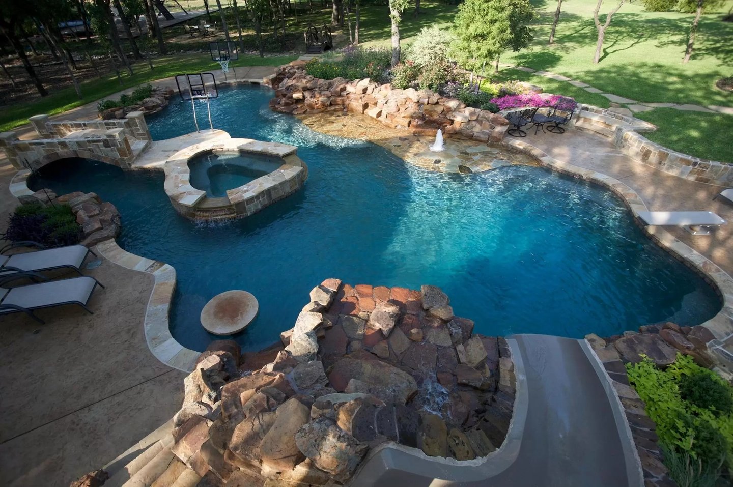 a pool with a waterfall and a jacuzzi