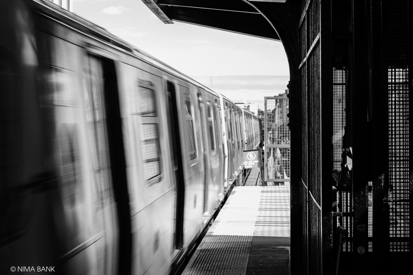 subway platform in bushwick brooklyn with train cars traveling fast creating blur