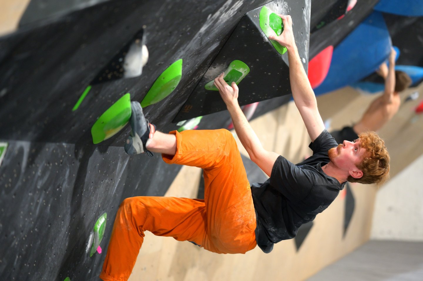 a man bouldering in a climbing competition