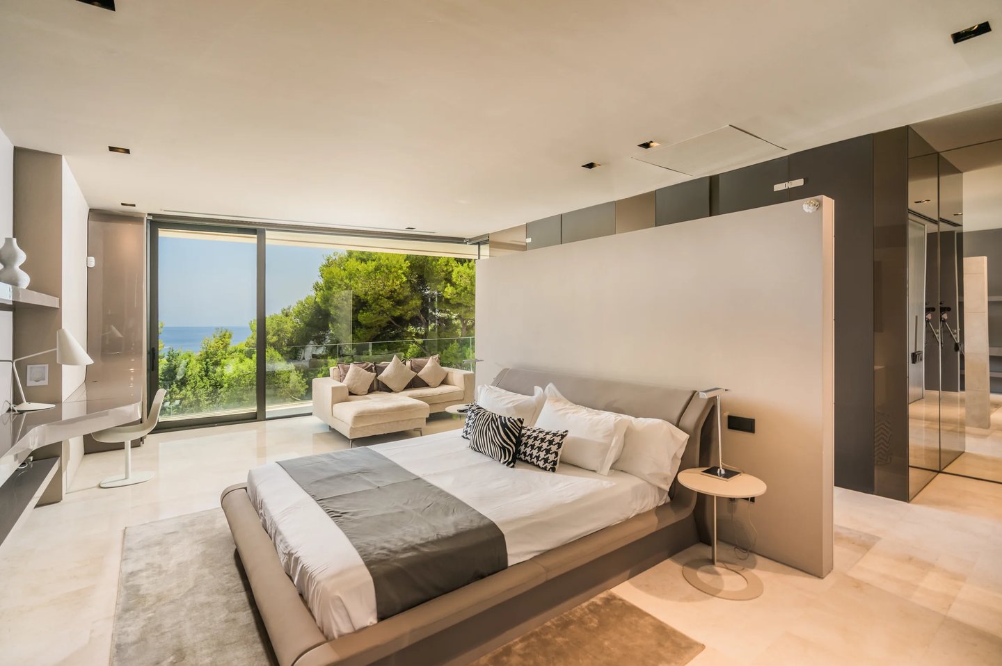 Spacious bedroom suite with lounge area and sea views