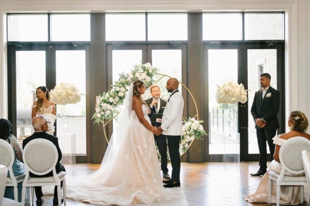 a bride and groom standing in front of a wedding ceremony
