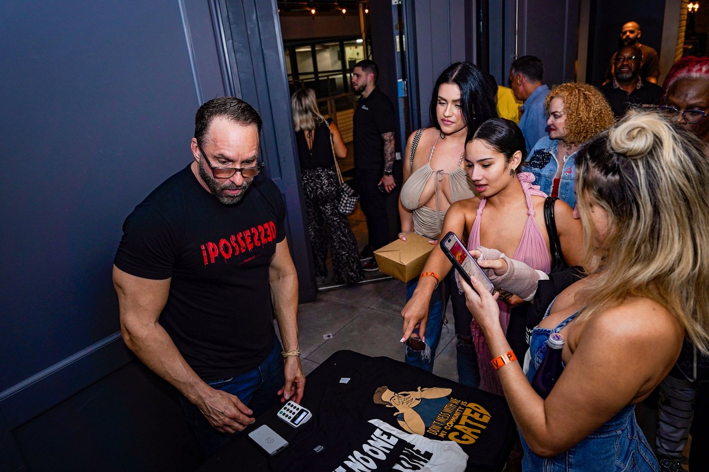a man and woman standing in front of a table with a sign