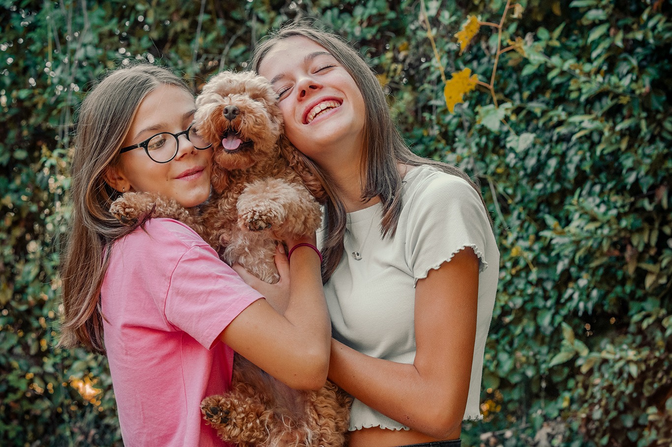 ritratto di bambine sorridenti col proprio cane in natura
