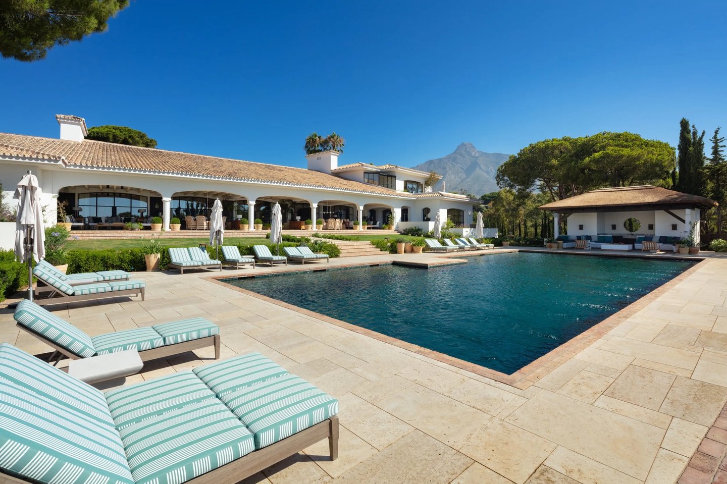 Main pool at Villa La Gratitud with sunbeds and Mediterranean backdrop