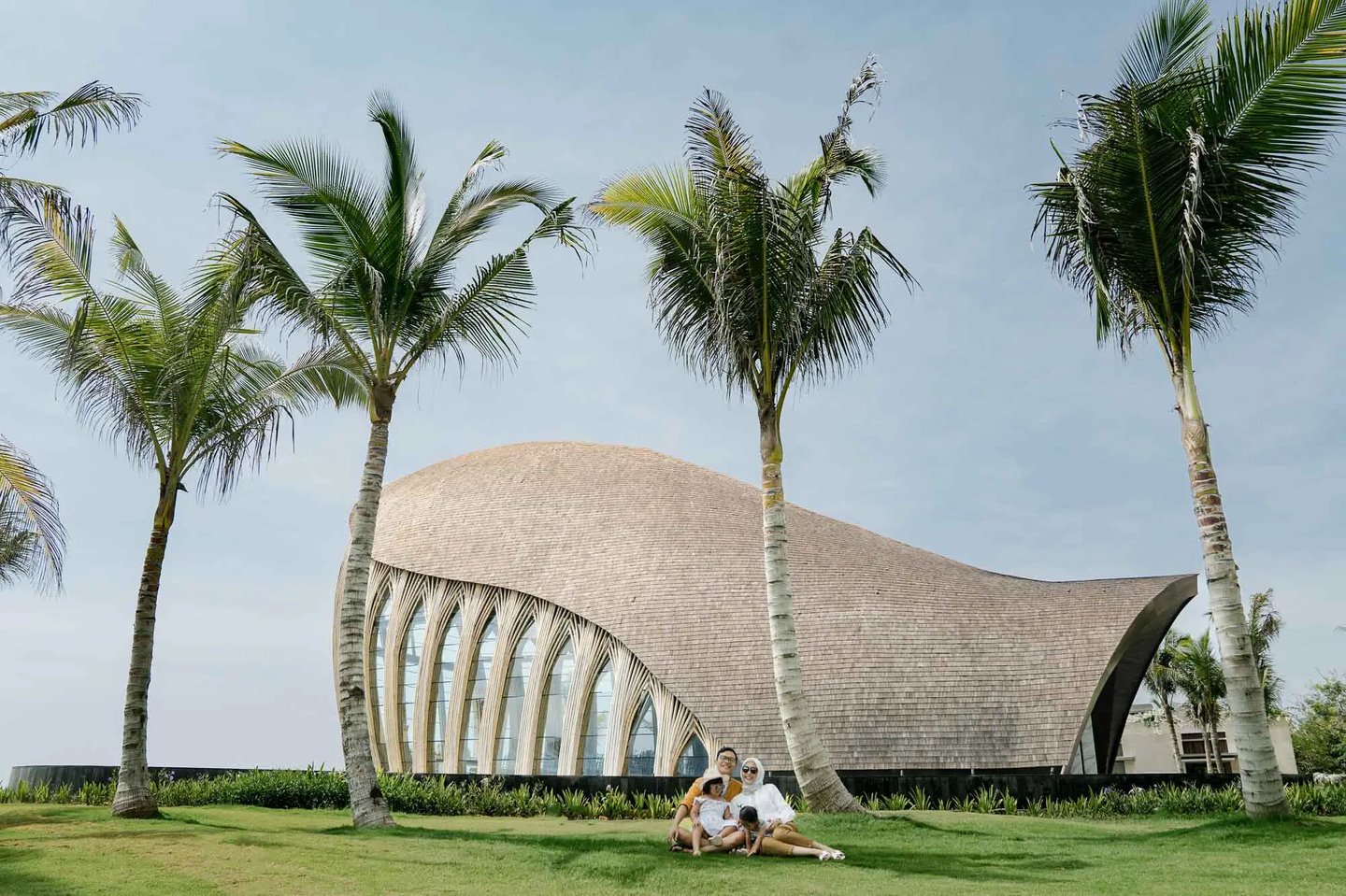 Family portrait in front of The Apurva Kempinski Bali chapel overlooking the Indian Ocean