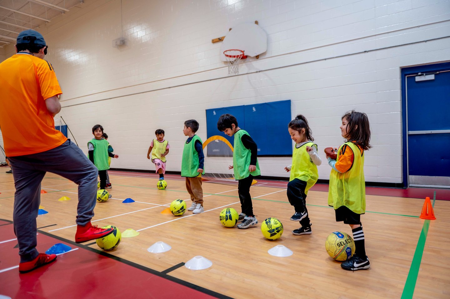 Young children MVB FC students practicing soccer ball control drills during an indoor Mississauga