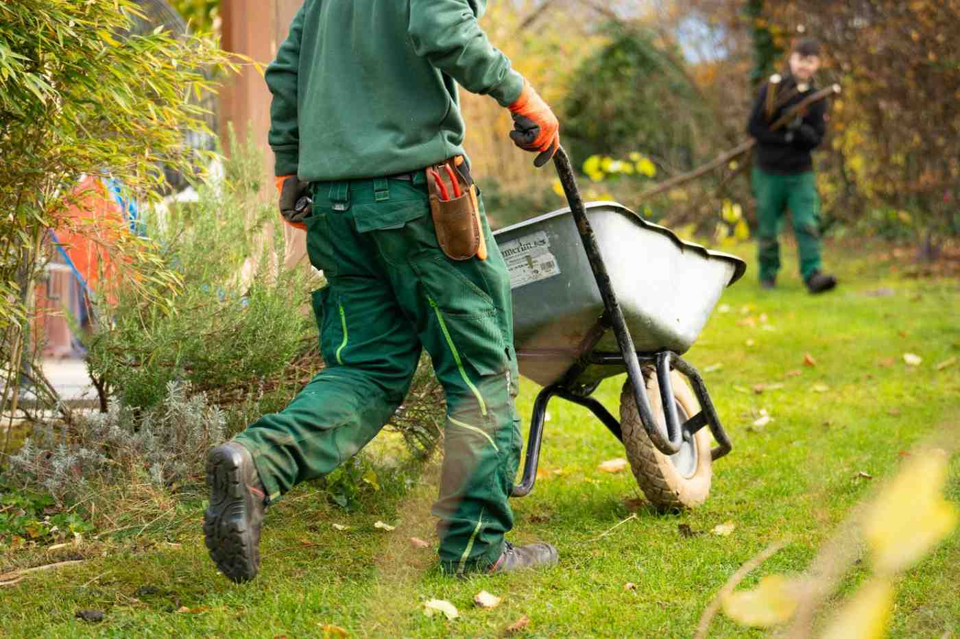 Professional landscaping crew installing sod and plants at a Tulsa residential property