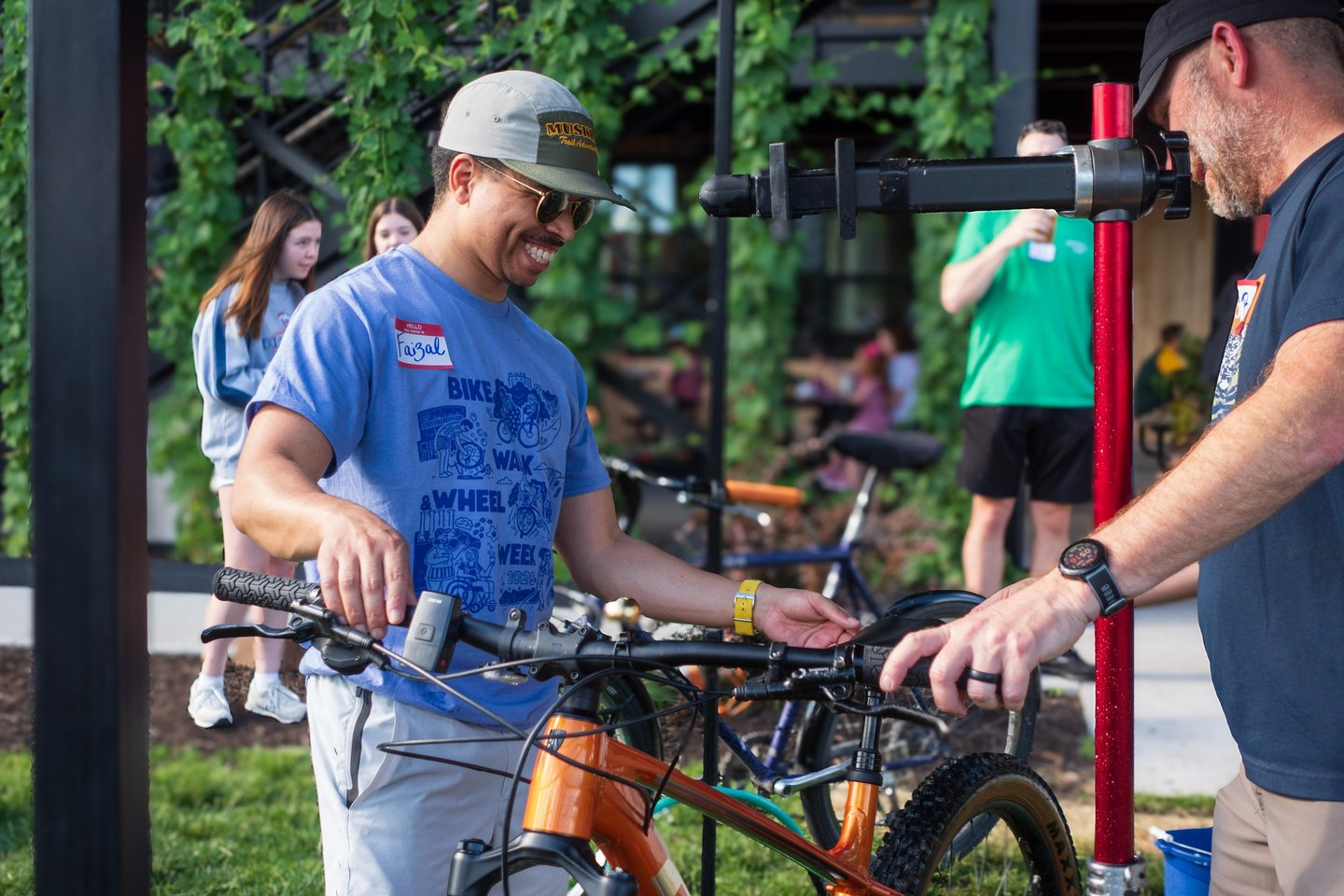 Person smiling handling a bike after cleaning it!