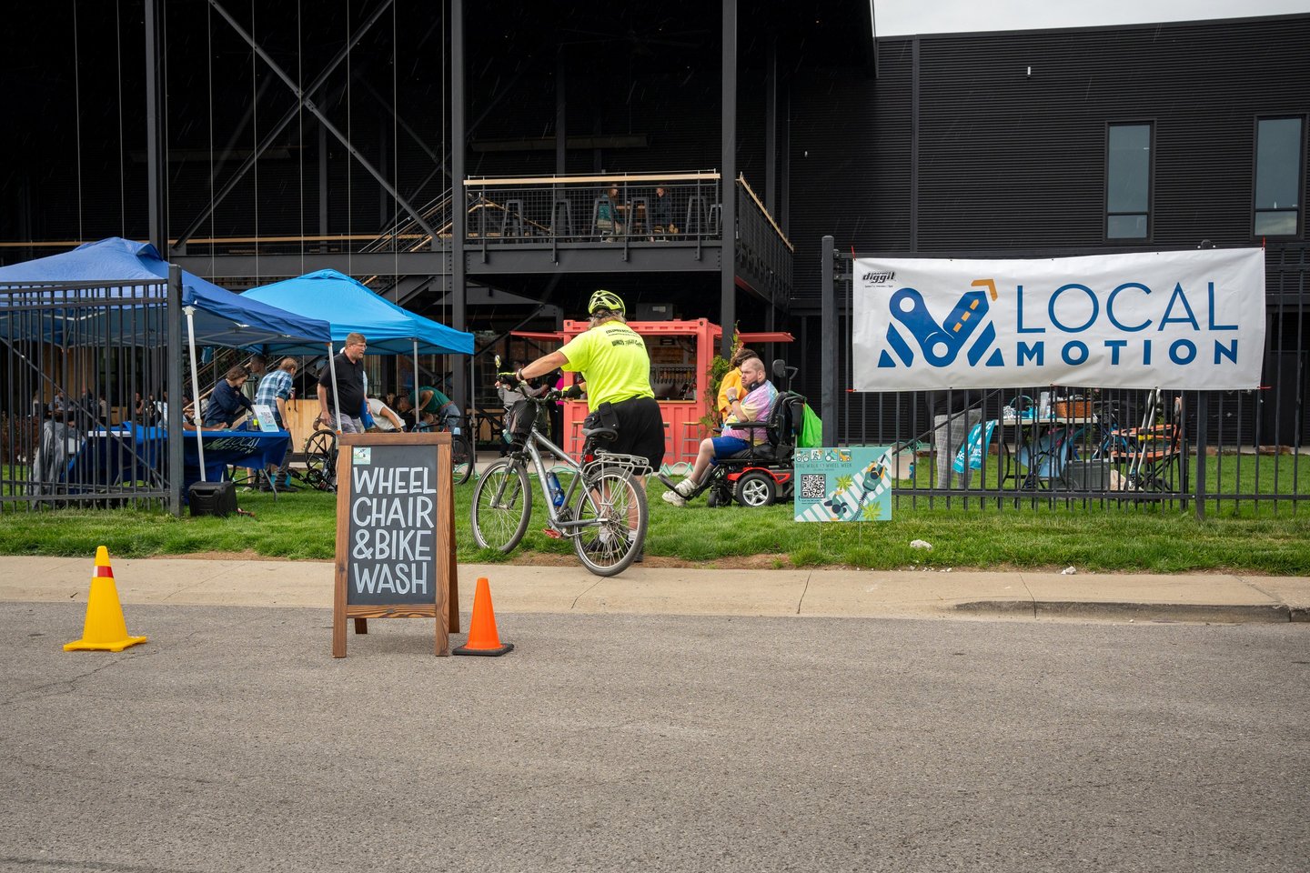 Photo of the event in the Logboat green area with the "Wheelchair & Bike Wash" sign in the road
