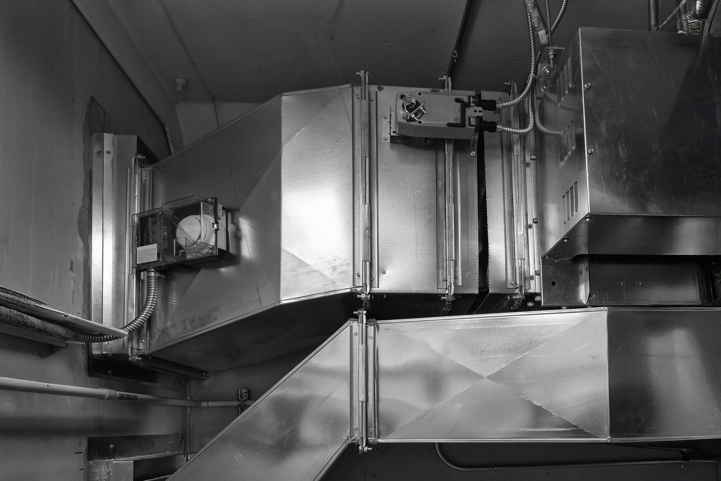 Industrial HVAC metal air ductwork system with motorized fire dampers for commercial ventilation.