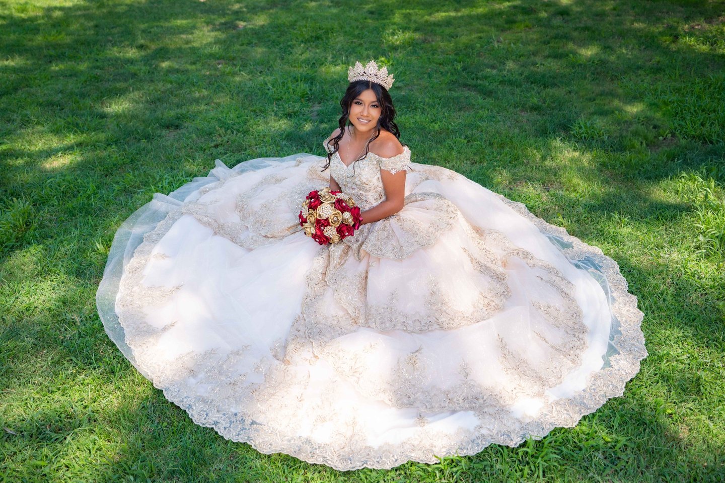 Professional Quinceañera photography in Visalia featuring a girl in a white and gold gown.