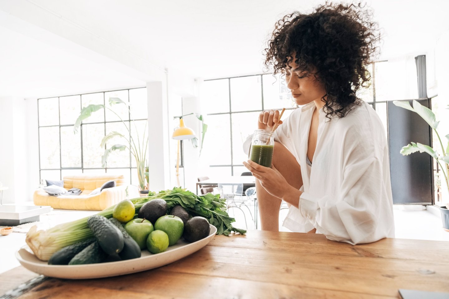 Woman drinking a healthy juice after yoga class