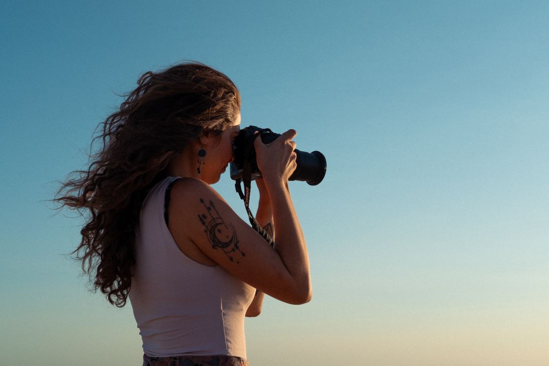 a woman taking a picture with a camera