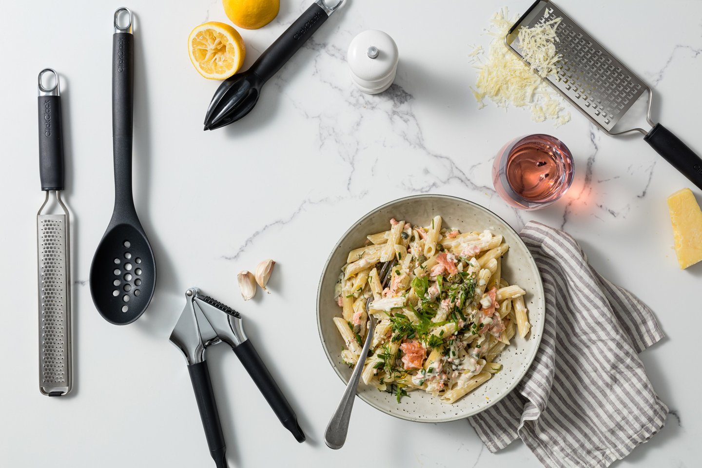 Food product photography - a bowl of pasta with a glass and utensils