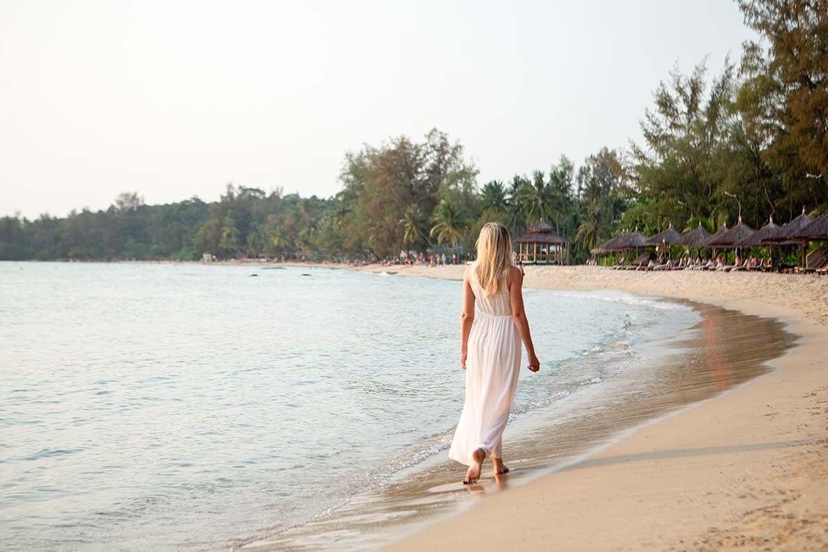 Woman walking along the beach during a sunset photoshoot in Phu Quoc