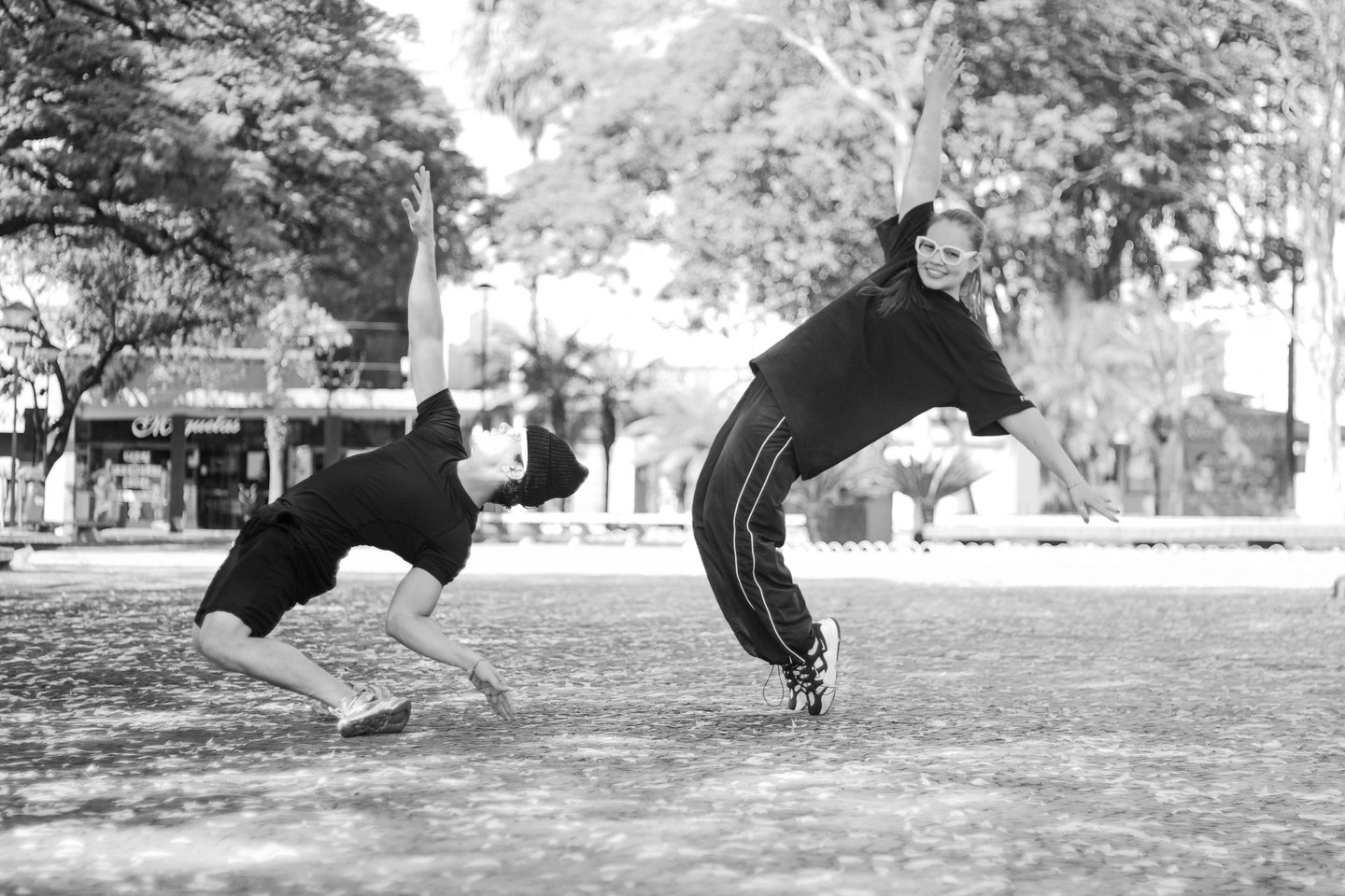 a man and a woman playing baseball in a park