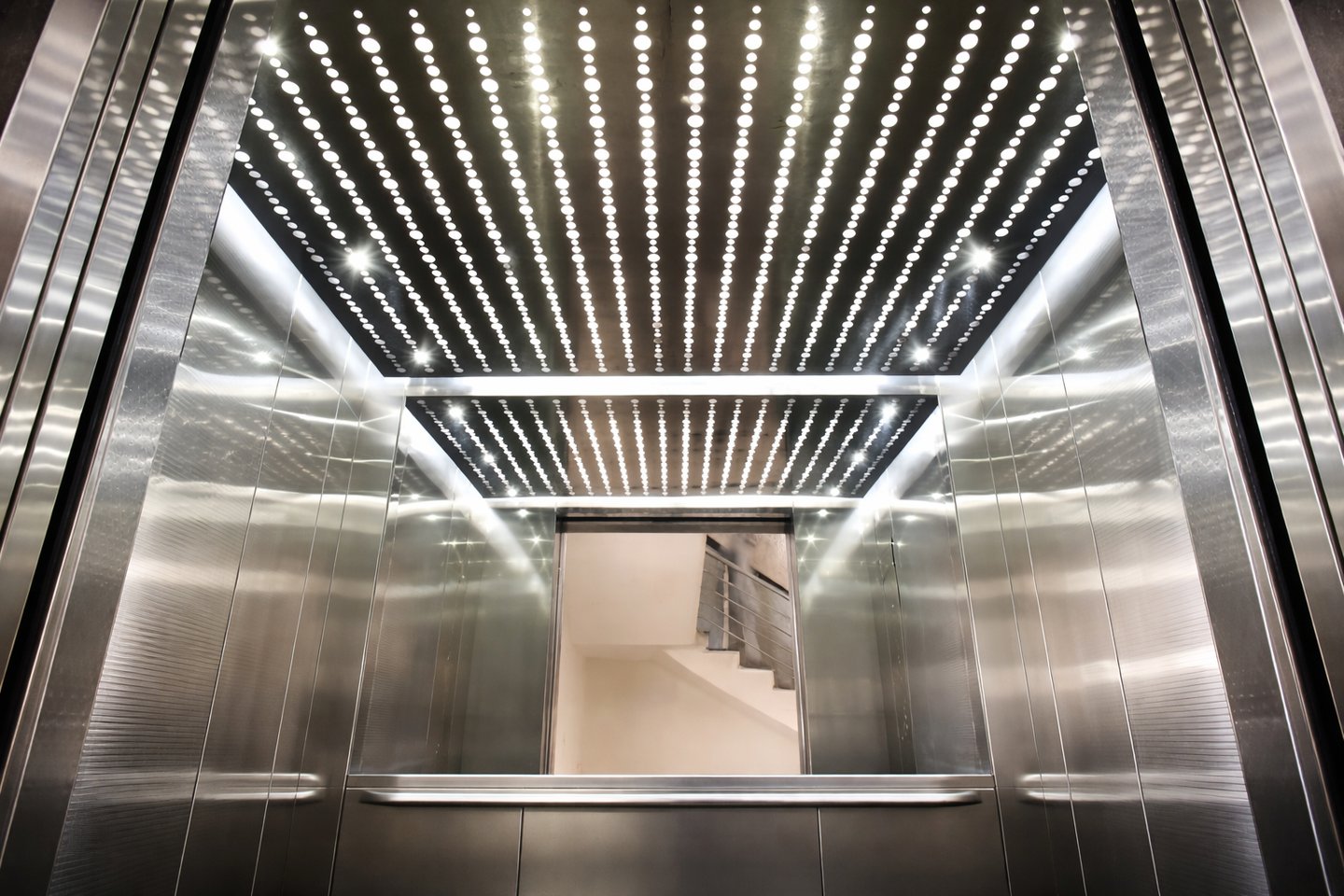 Modern passenger elevator with LED ceiling lighting and stainless steel interior