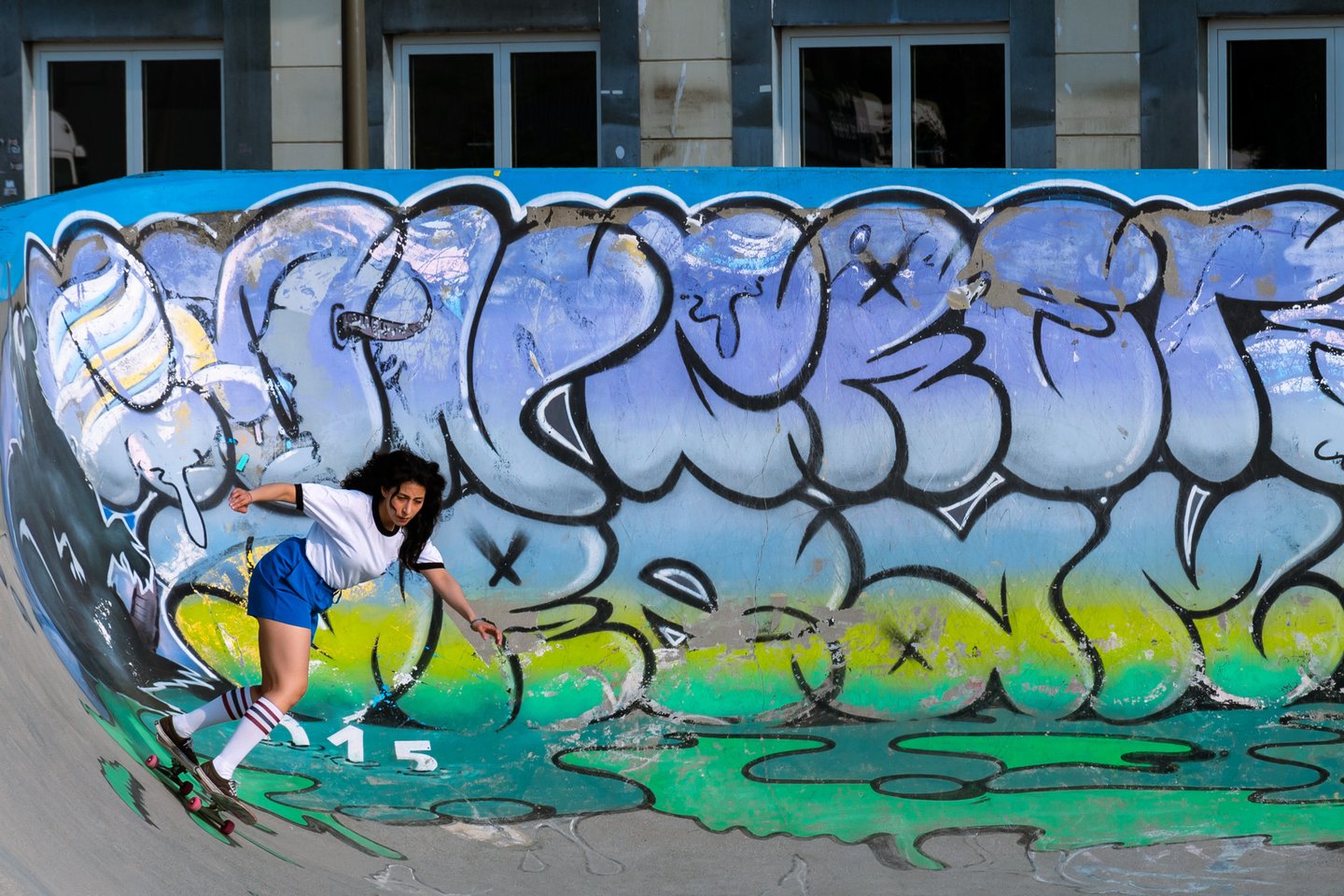 a skateboarder is riding her skateboard on a ramp