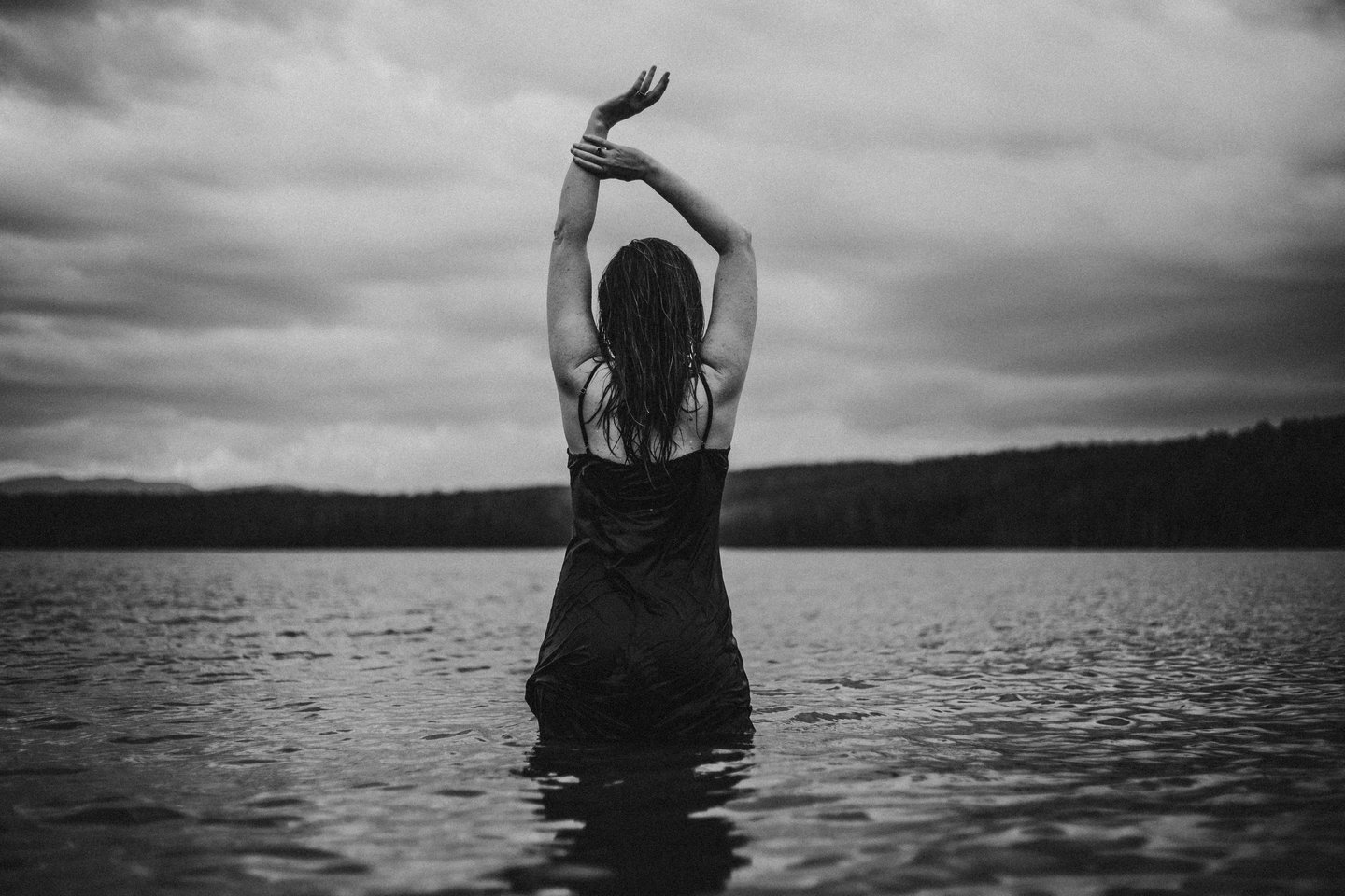 a woman in a swimsuit standing in the water
