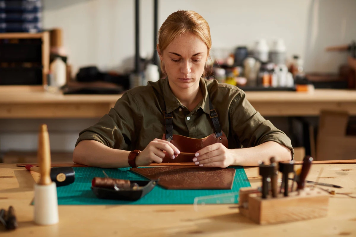 a woman in a green shirt and a brown wallet