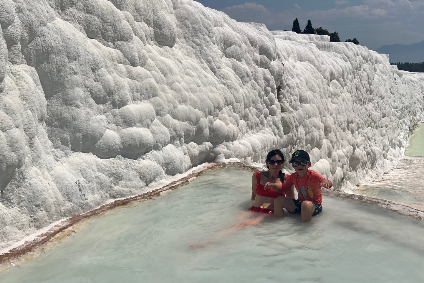 family swimming in pamukkale 