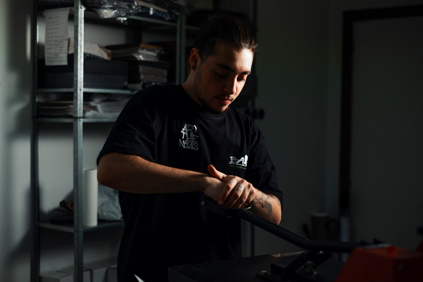 a man in a black shirt is holding a baseball bat