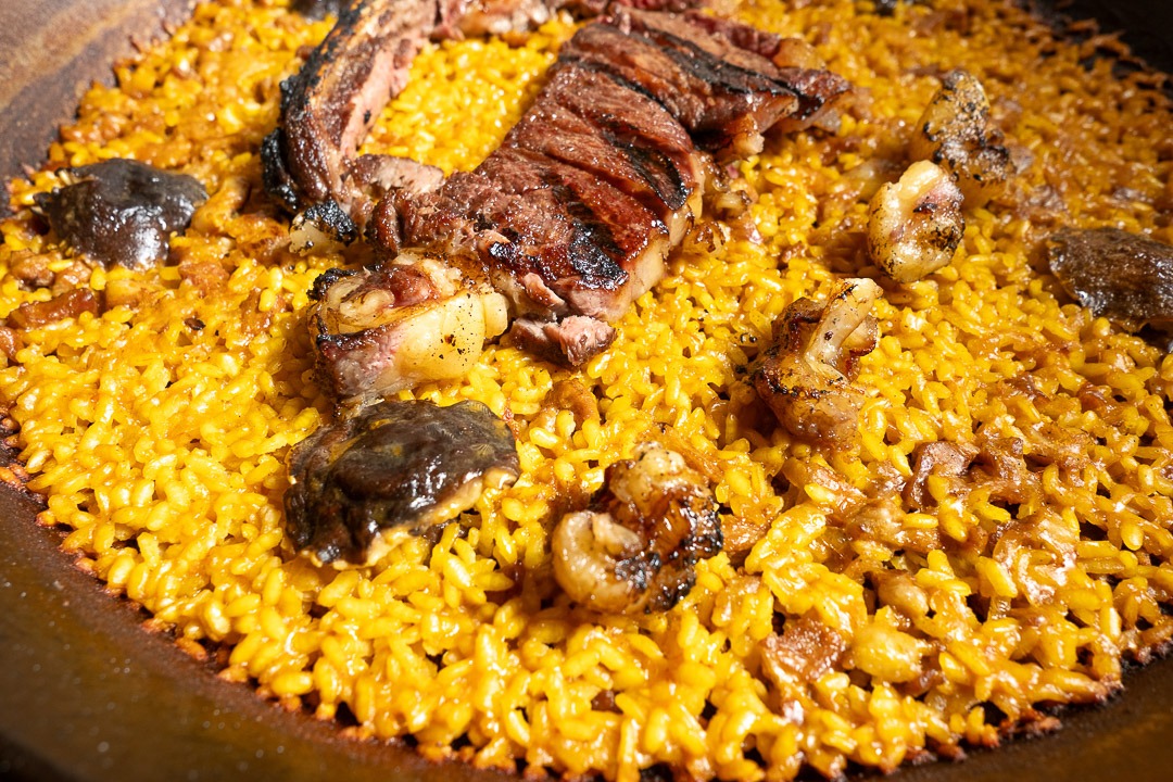 a large pan of food with meat and vegetables