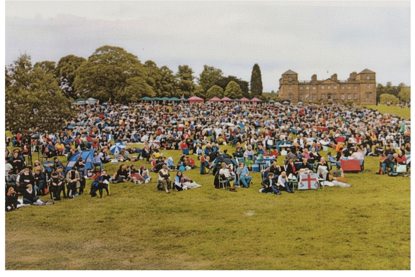 Crowds sitting on a lawn during for first Romany Wood performance at Hagley Hall