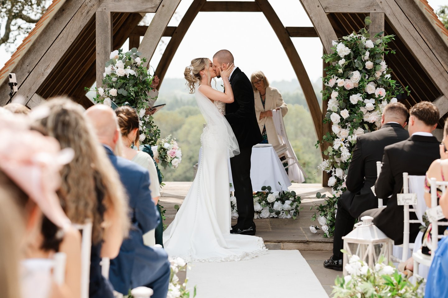 Bride and groom sharing their first kiss at Highley Manor