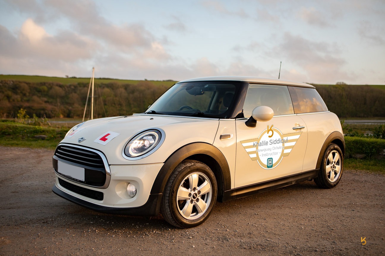 White Mini Cooper driving school car with L-plates for learner lessons in Newquay.