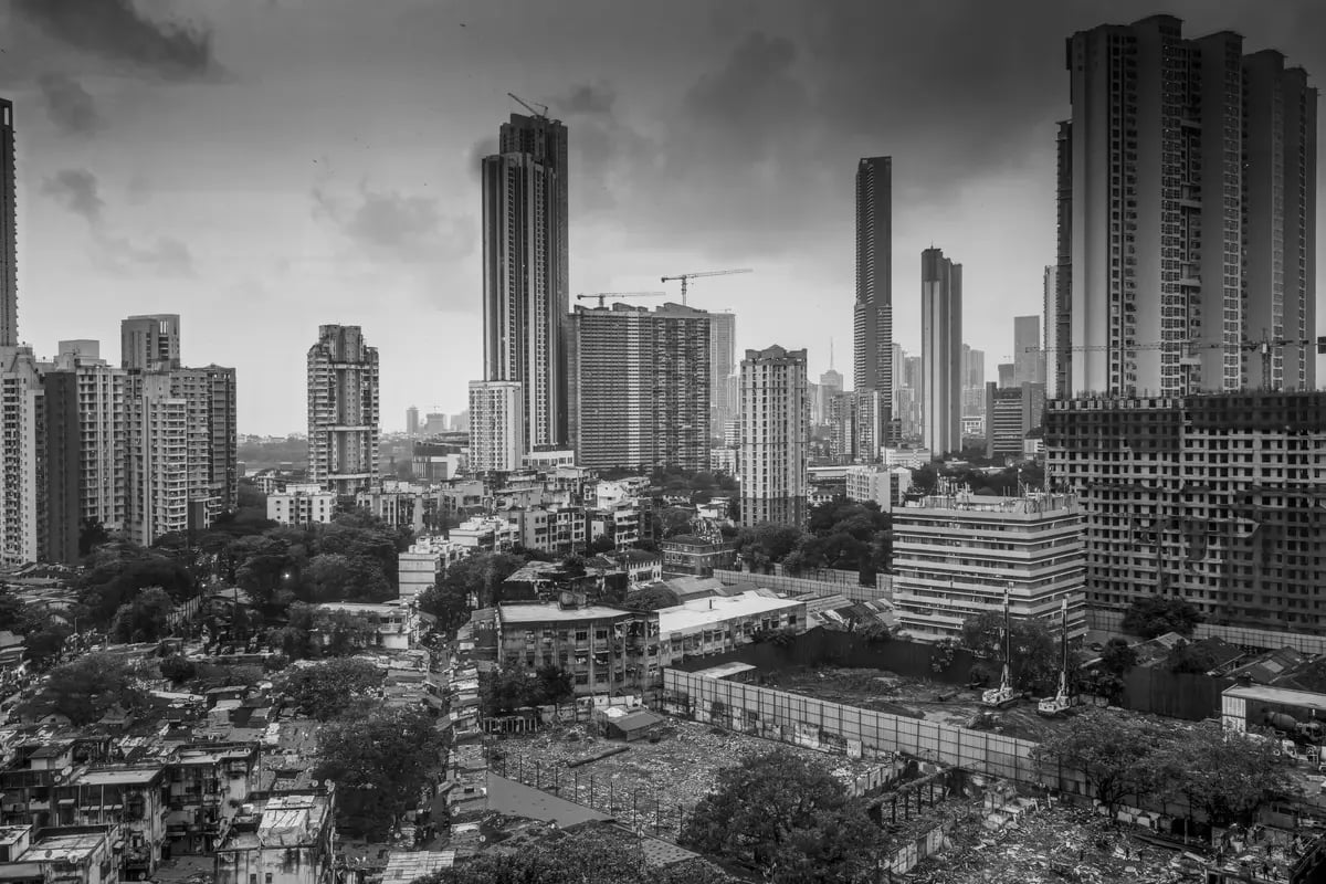 Black and white cityscape of Mumbai skyline featuring tall skyscrapers and urban development.