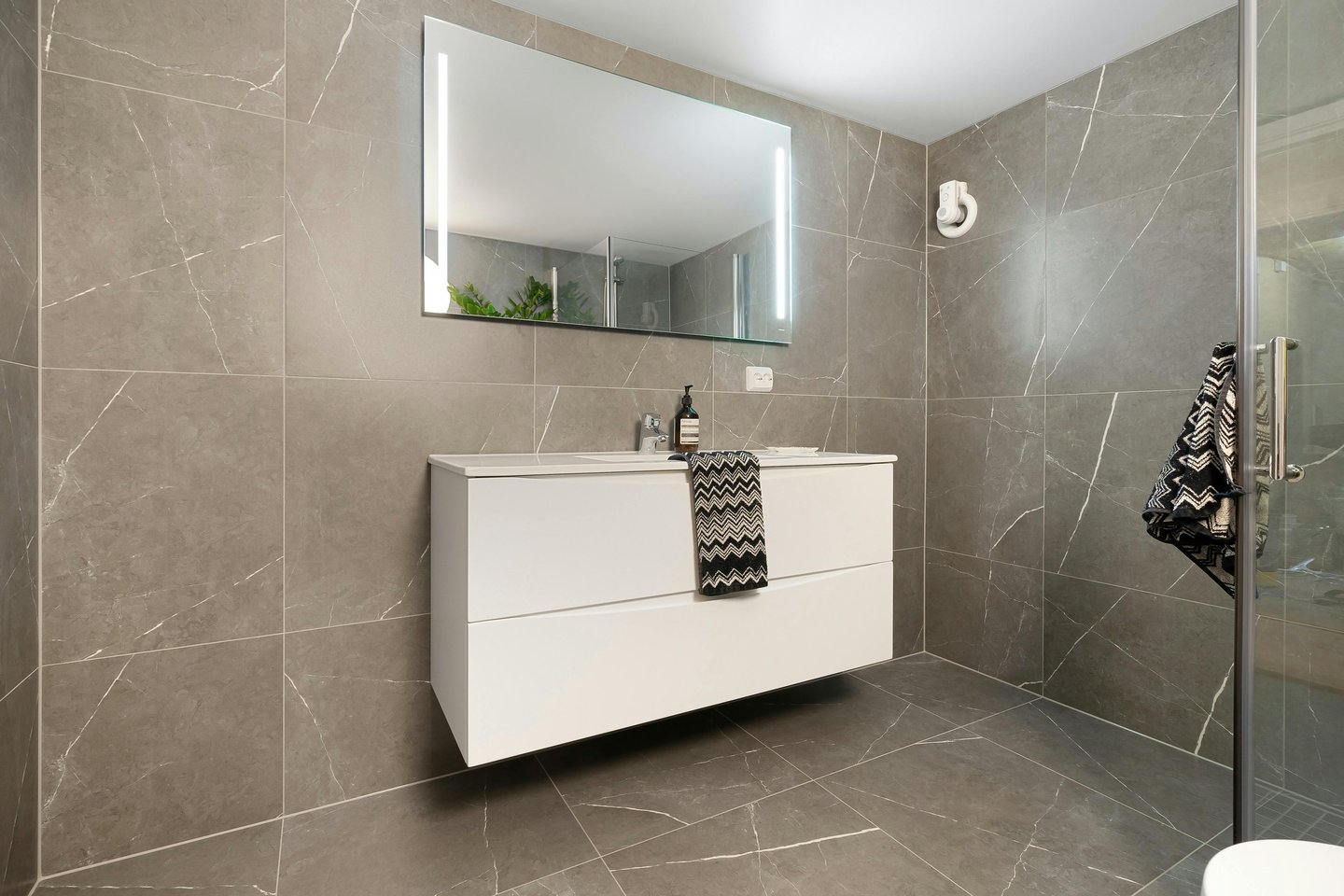 a bathroom with a white sink and a mirror
