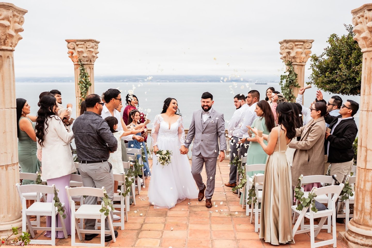 a bride and groom walking down the aisle of a wedding ceremony