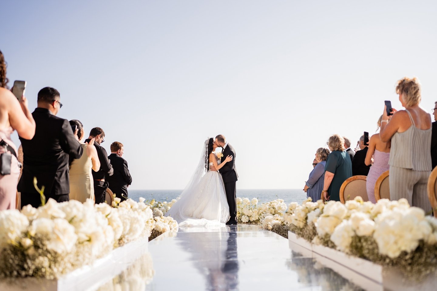 a bride and groom kissing on a wedding day