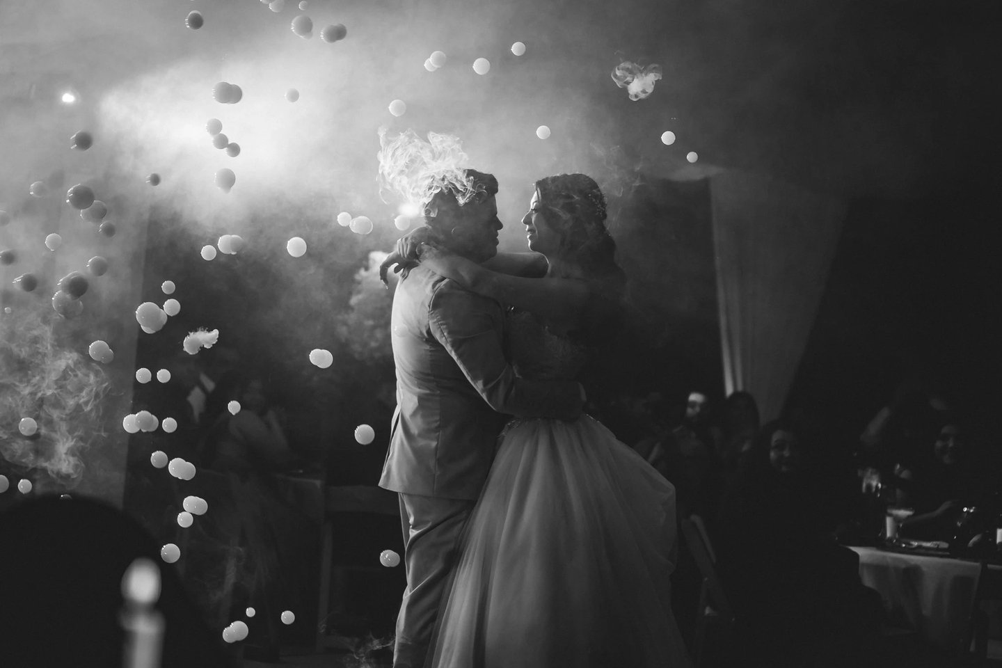 a bride and groom share a kiss at their wedding reception