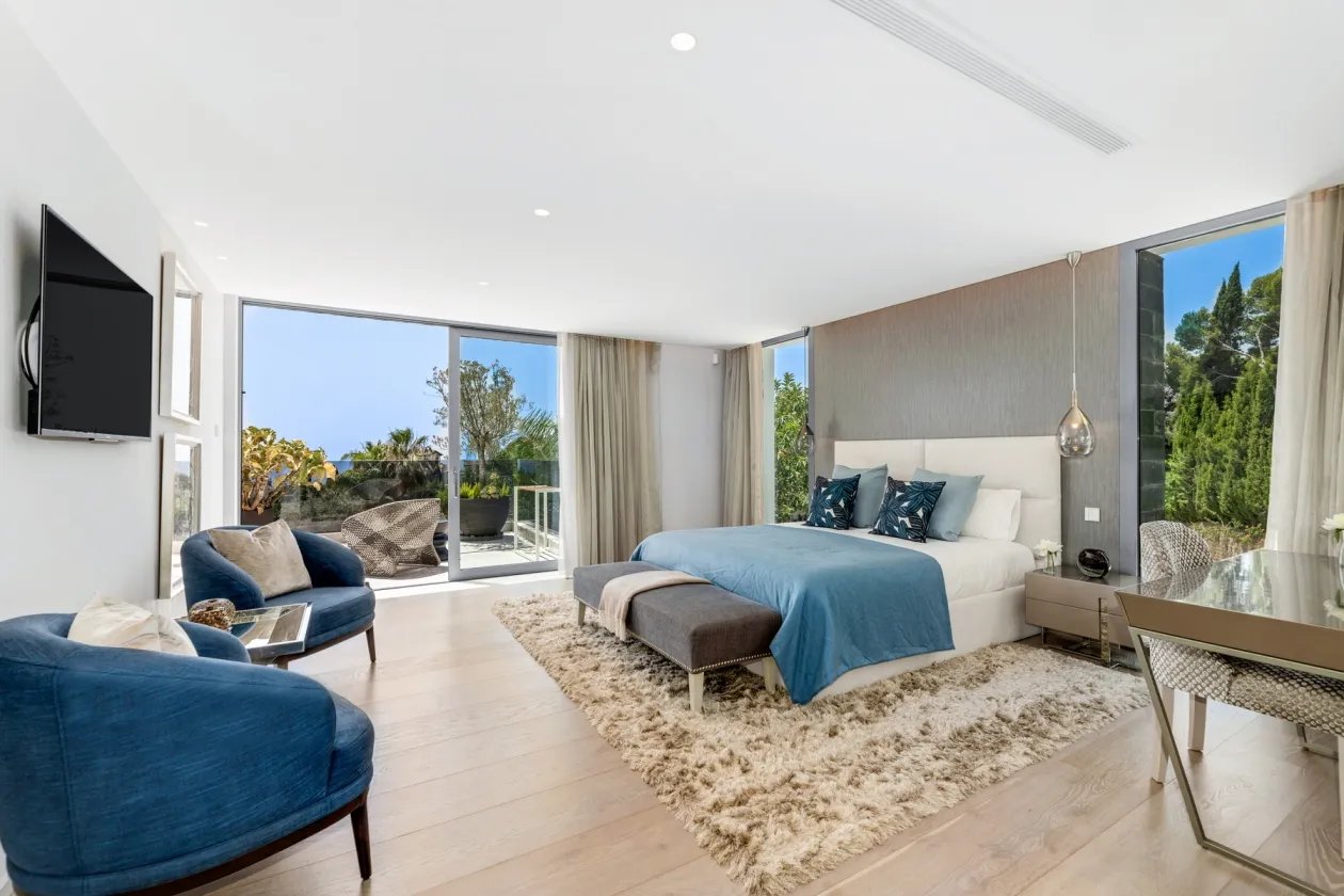 Elegant suite at Villa Serenity with blue chairs and sea outlook