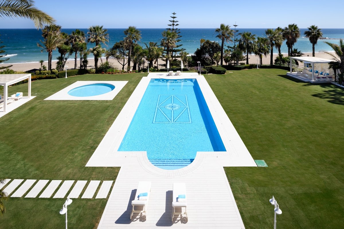 Beachfront pool and gardens at Marbella villa
