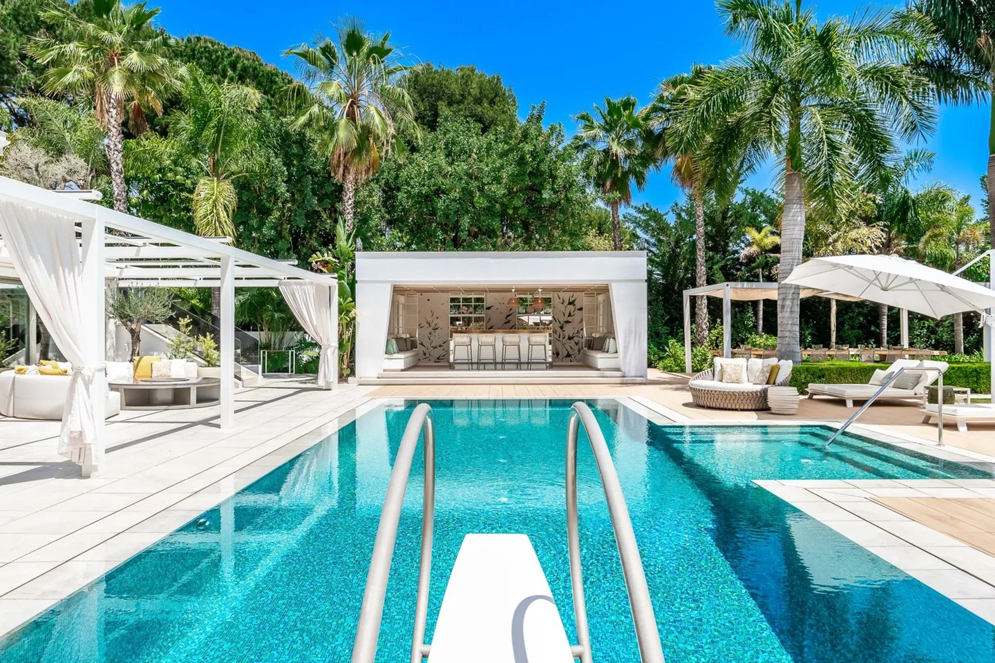 Poolside loungers and shaded pergola at Villa Serenity
