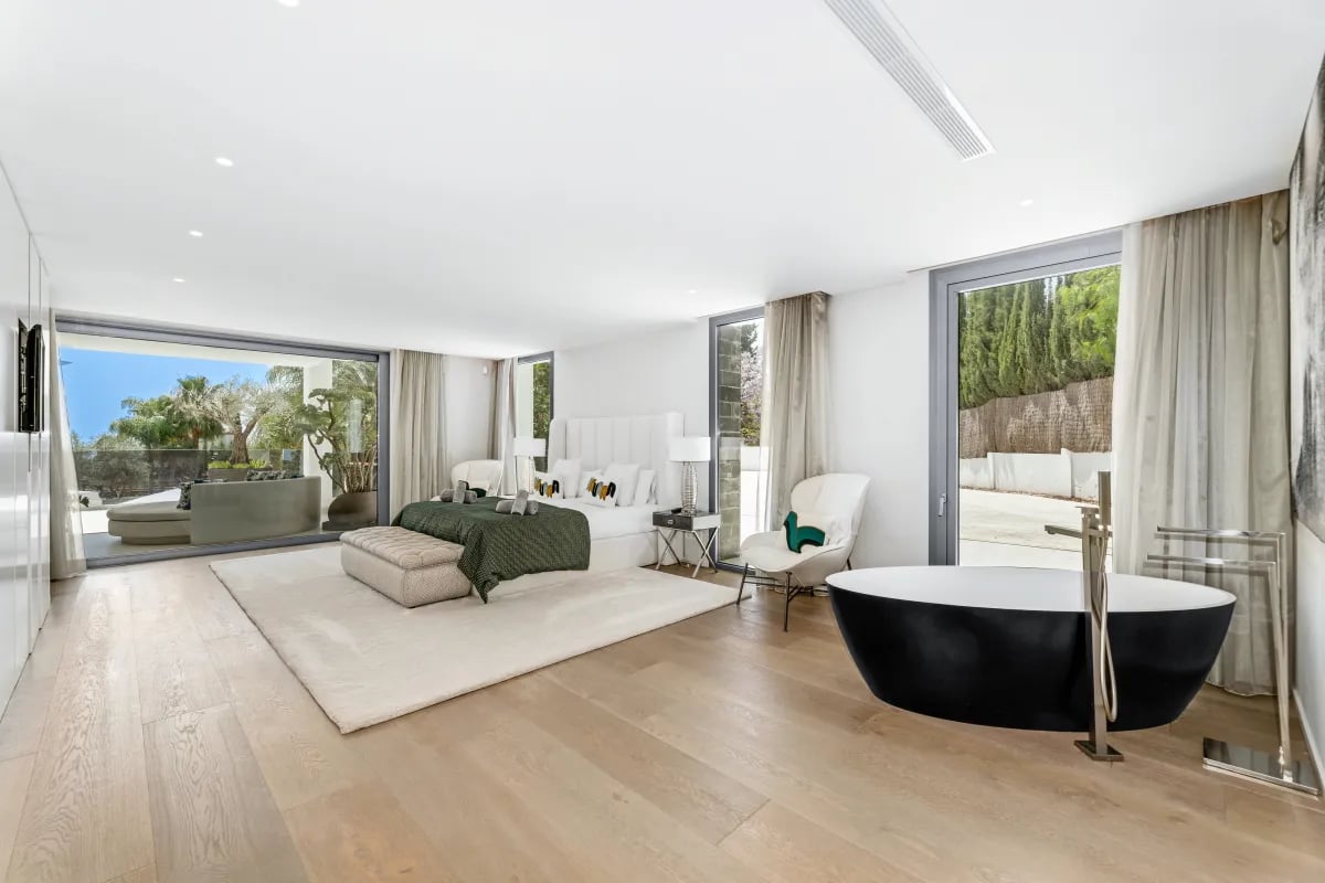 Villa Serenity suite with freestanding black tub and terrace view