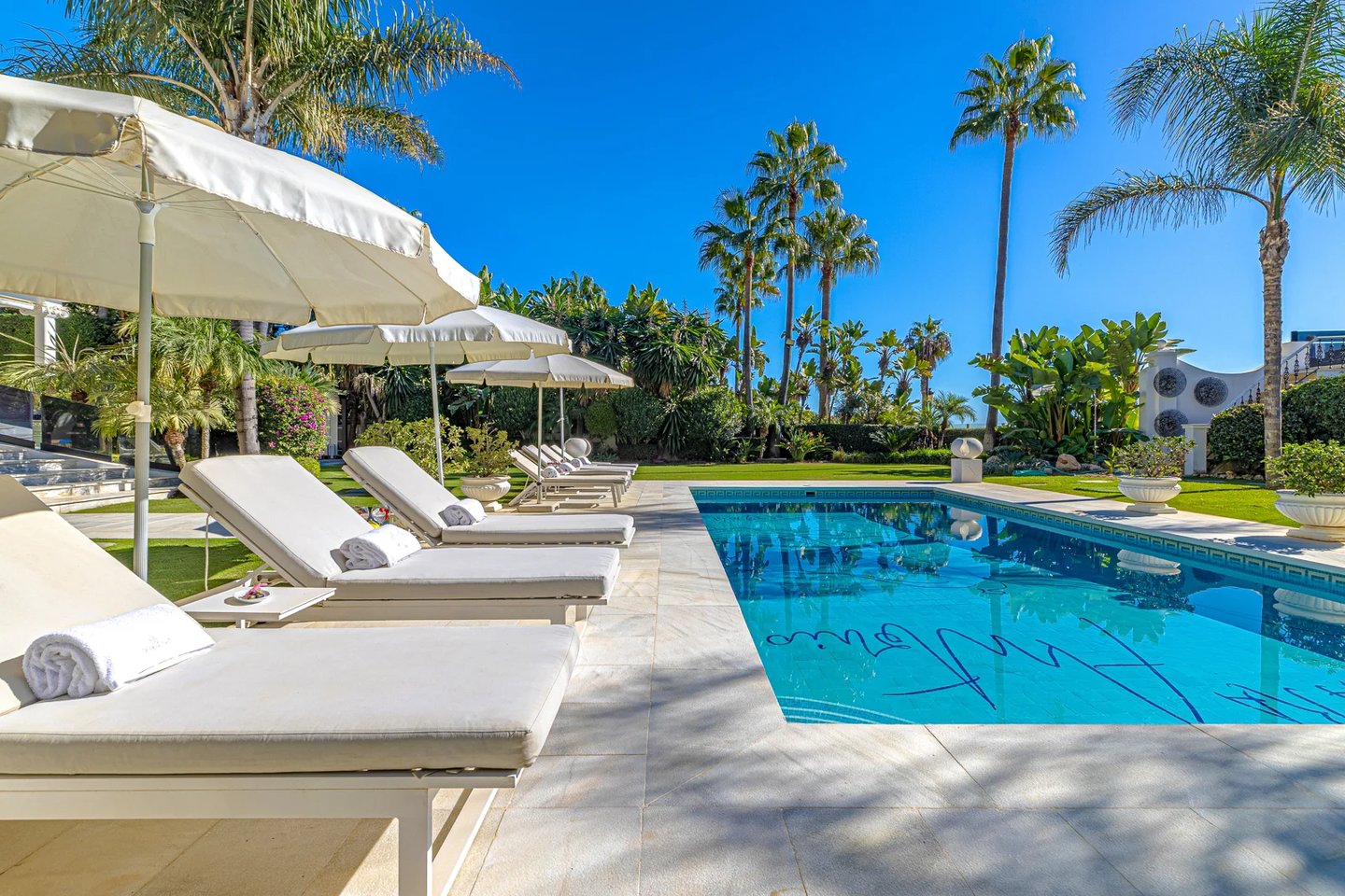 Sun loungers by private pool in luxury Marbella villa near Puerto Banus