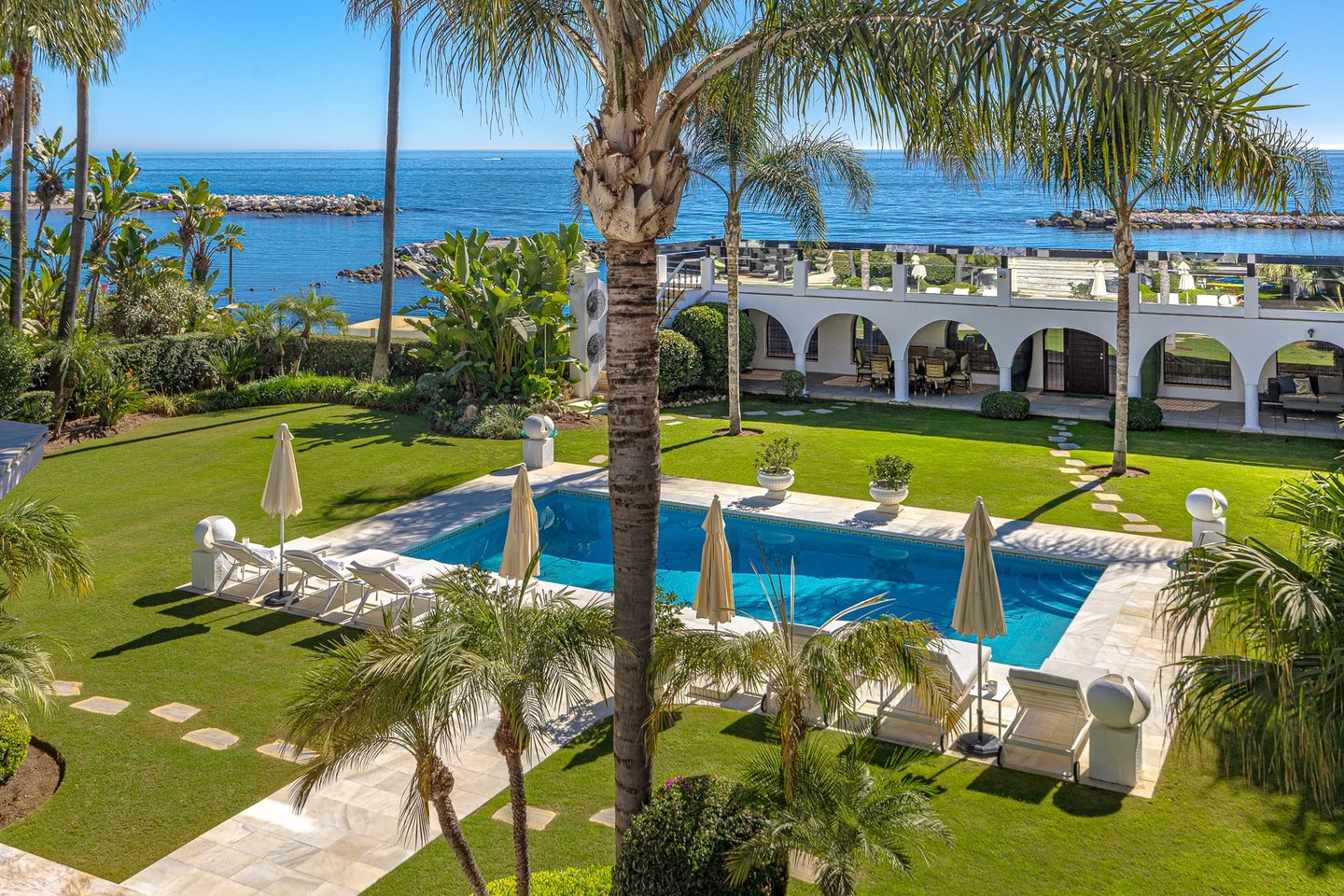 Garden and pool area in beachfront villa Marbella with direct sea views