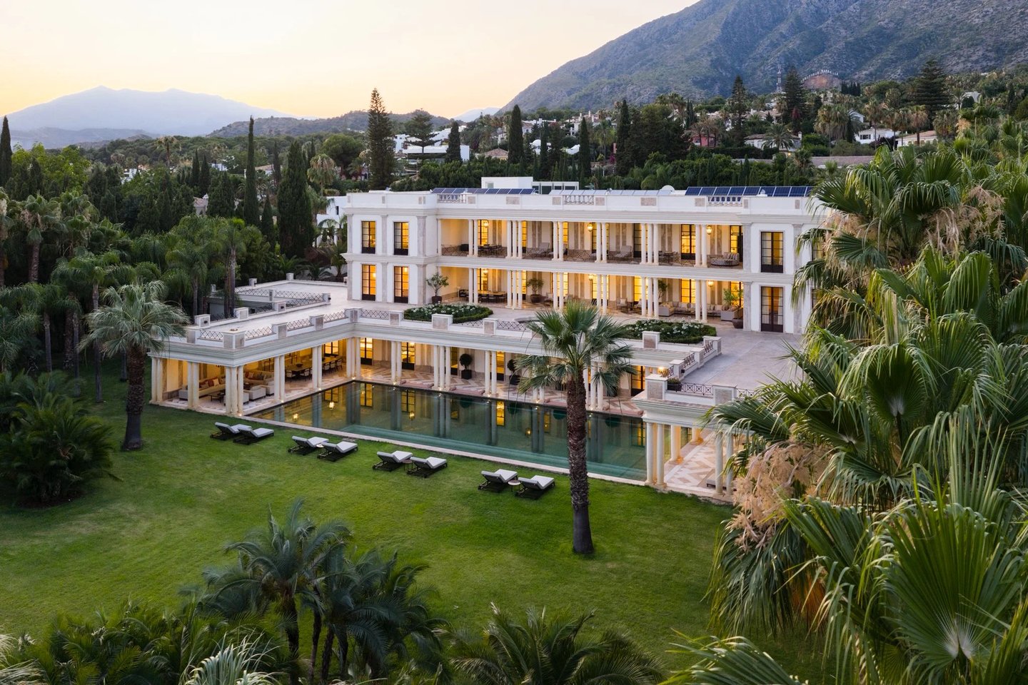 Aerial view of estate at dusk with pool and mountain scenery